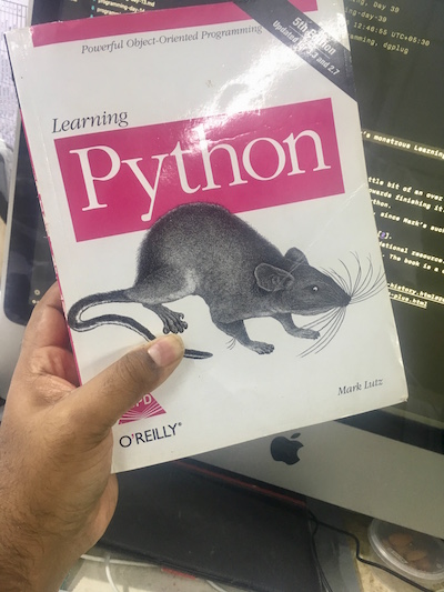 Me holding Mark Lutz’s monstrous Learning Python Book