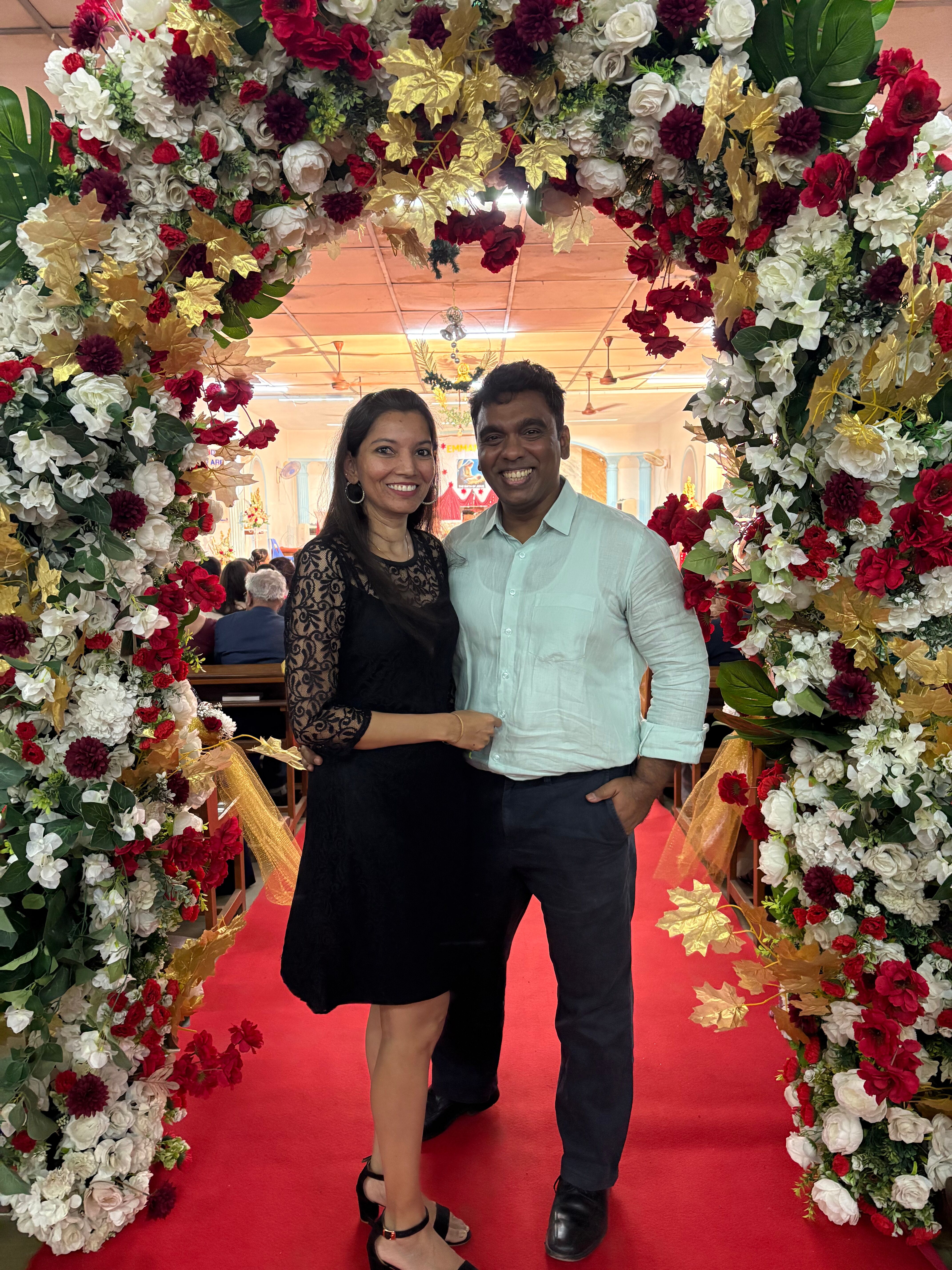 Photo of Abby and me in church under a floral arch