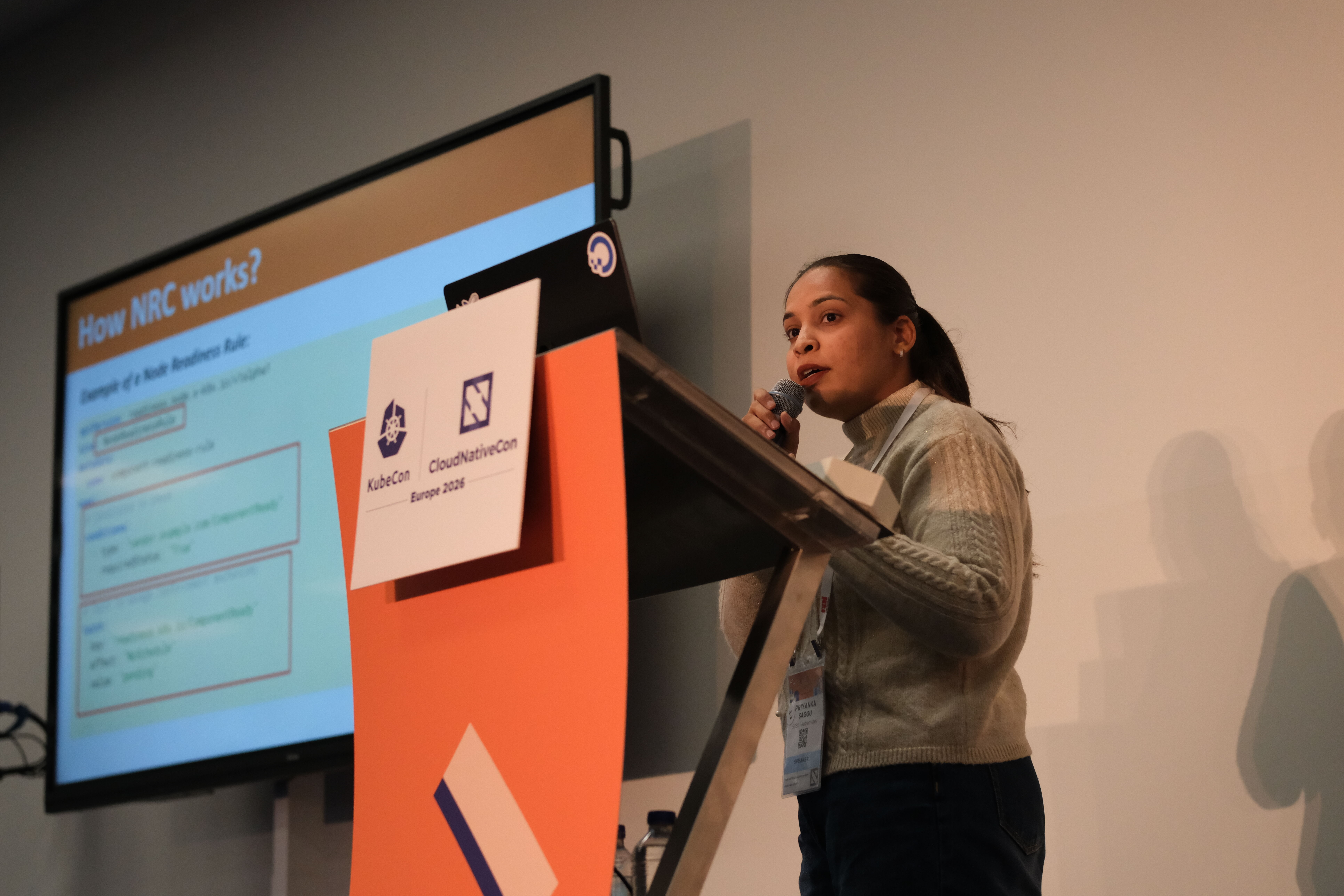 Photo of Priyanka giving a talk at Kubecon